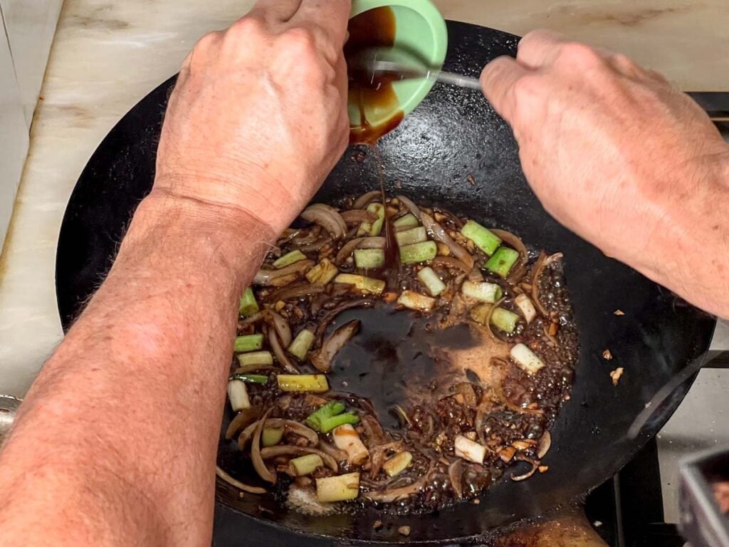 Adding sauce elements to the wok