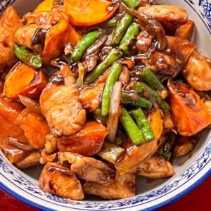 Birdseye view of Chicken w persimmons in a blue and white Chinese bowl