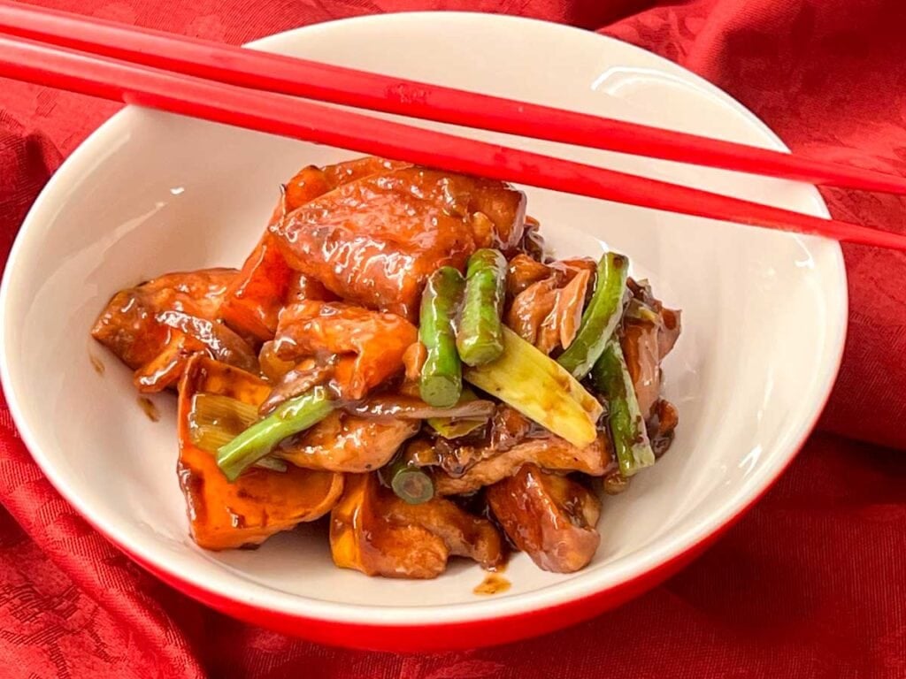 Chicken with persimmons in a small rice bowl with chopsticks