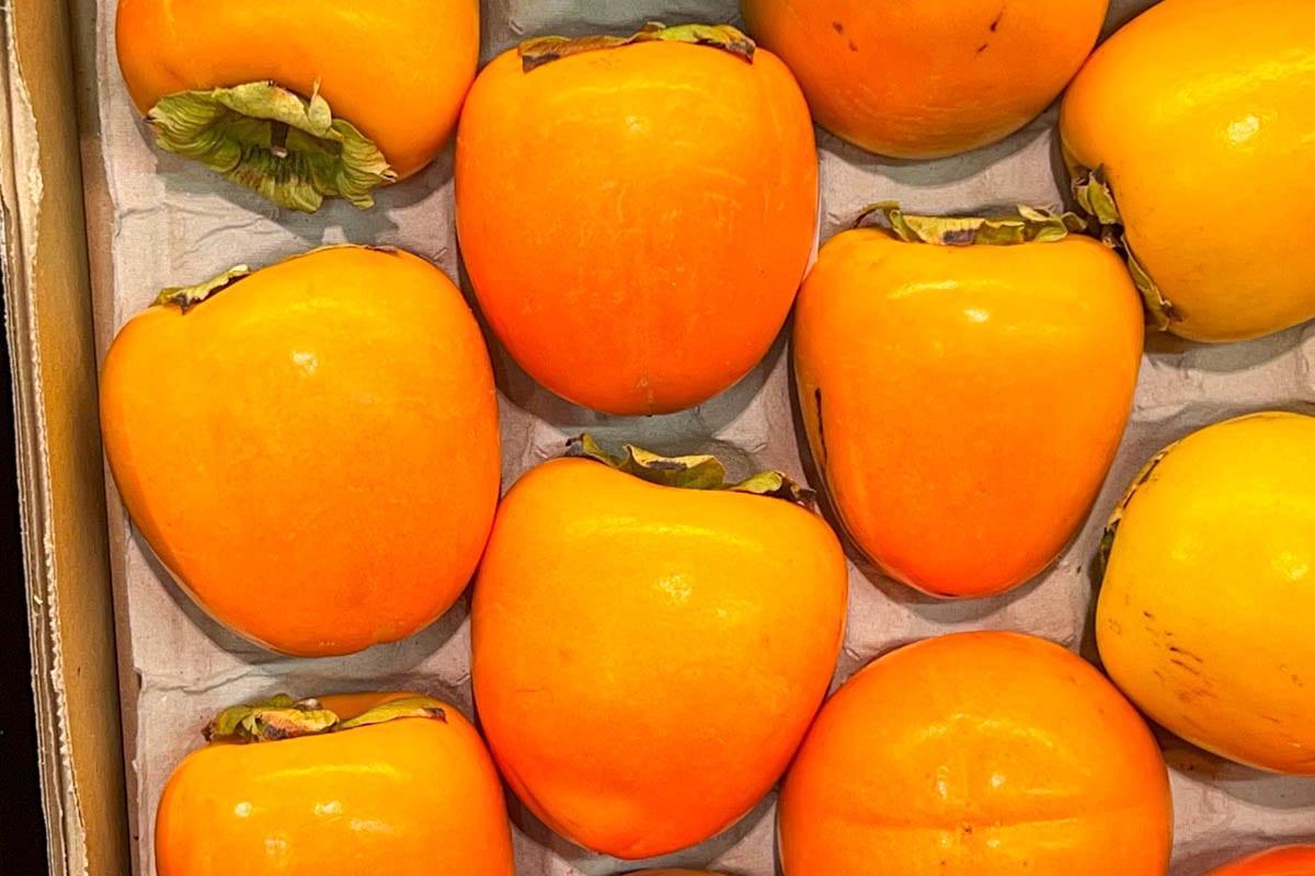Hachiya persimmons in a crate at a supermarket