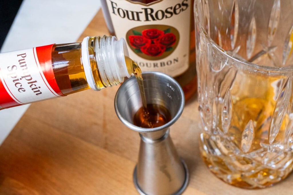 Measuring Pumpkin Spice Syrup for a Pumpkin Bourbon Smash