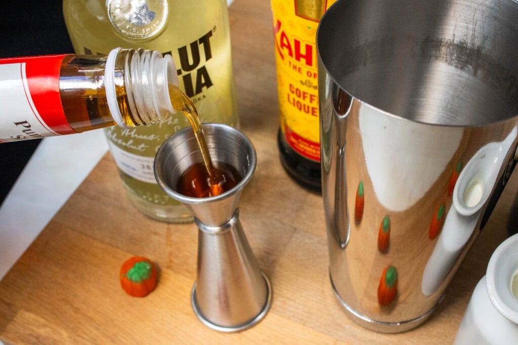 Measuring Pumpkin Spice Syrup for a Pumpkin Spice Martini