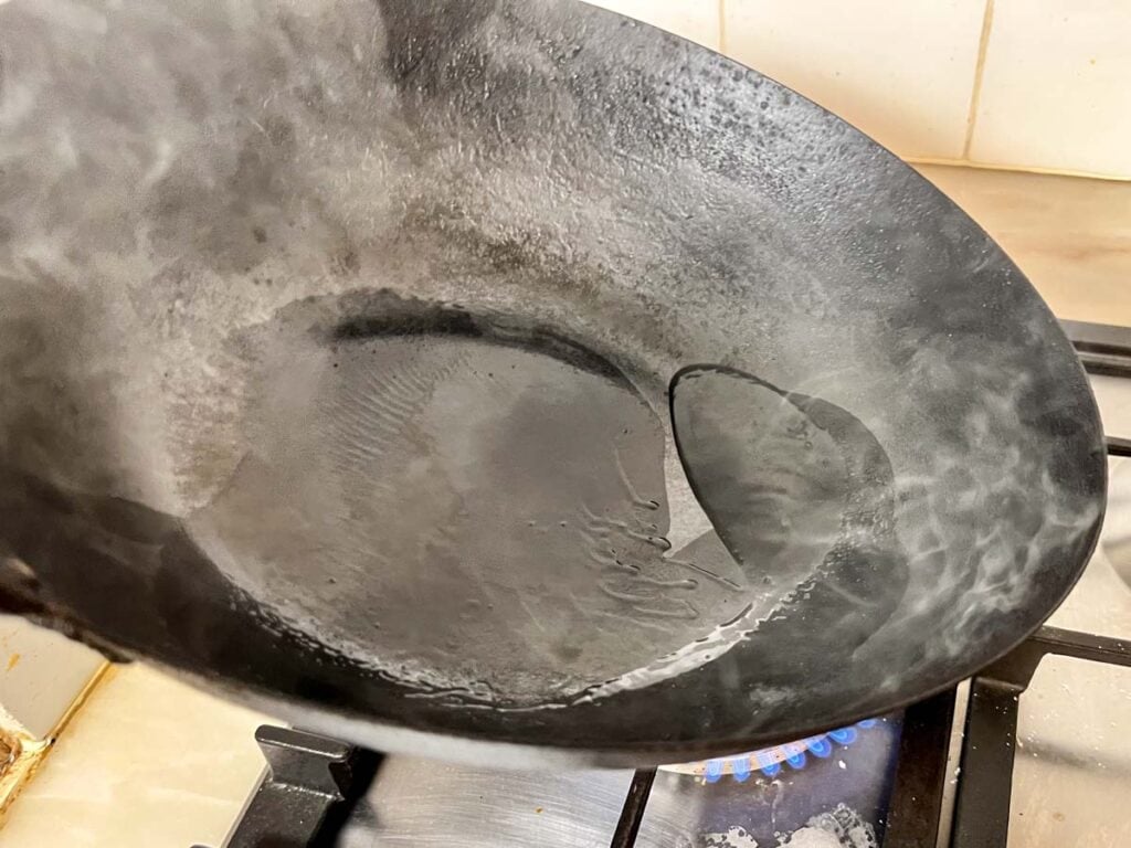 Preseasoning a hot wok with vegetable oil