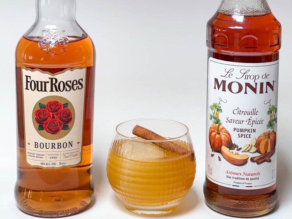 Pumpkin Bourbon Smash with Bourbon Bottle and Pumpkin Spice Syrup