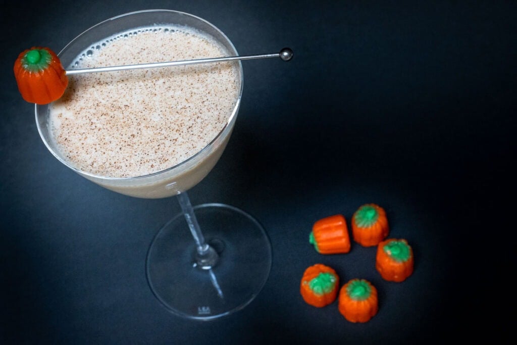 Pumpkin Spice Martini and Pumpkin Candies with Black Background