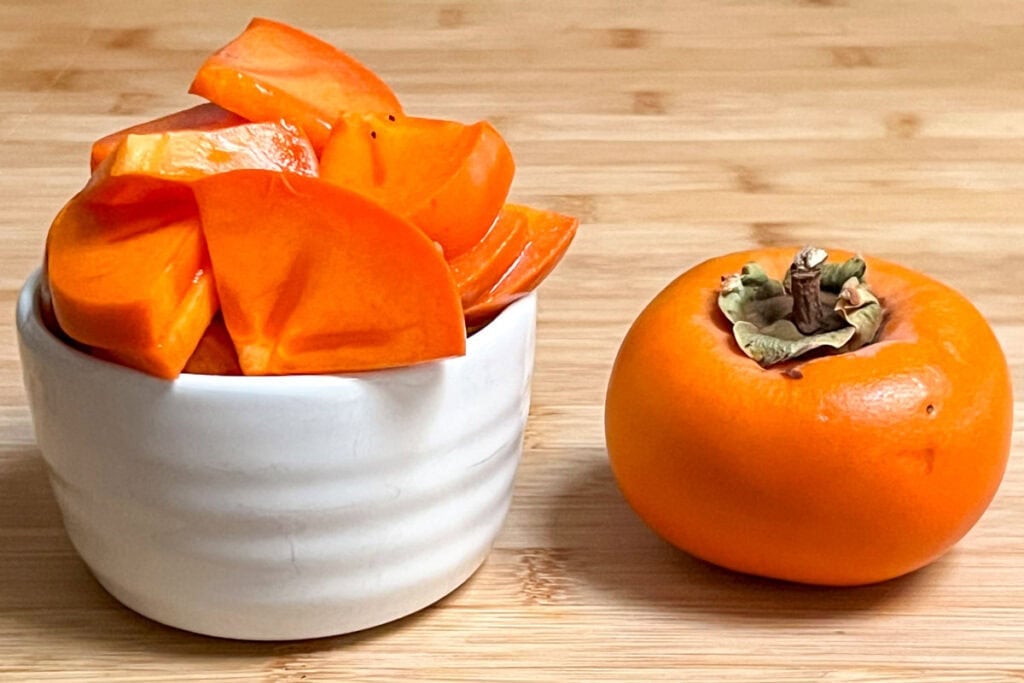 Sliced and whole fuyu persimmons