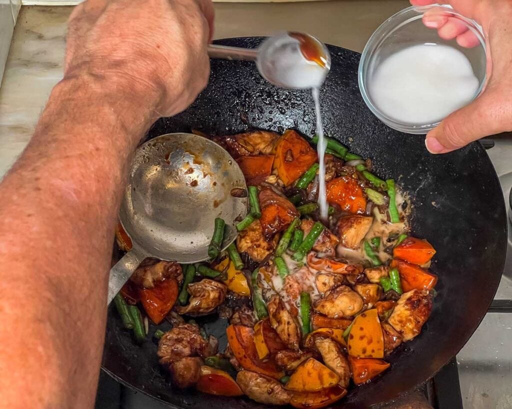 Thickening the stir-fry with a cornstarch slurry